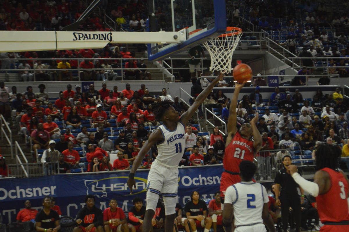 Port Allen junior Aries Lewis (11) attempts to block Winnfield senior Keithan Hamilton's shot during the Division III non-select championship game Saturday.
